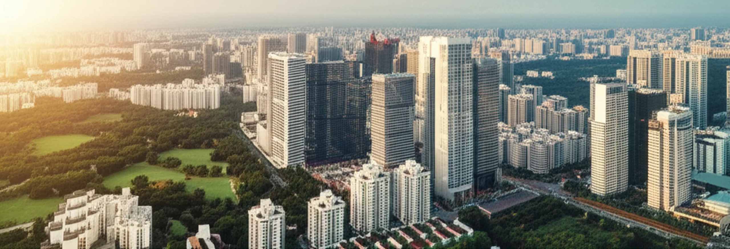 サラリーマン大家の与信戦略｜高属性が資産形成で有利な理由 - 都心のオフィスビル群と住宅街が共存する空撮写真。朝の光が差し込む都市の風景